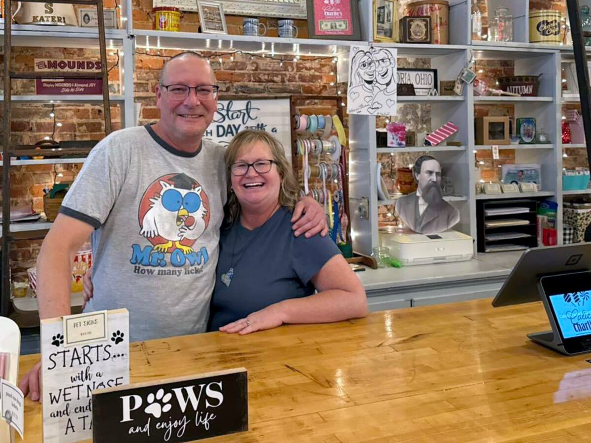 Kristin and Matt Koester inside Calico Charlie’s, surrounded by shelves of candy and local gifts